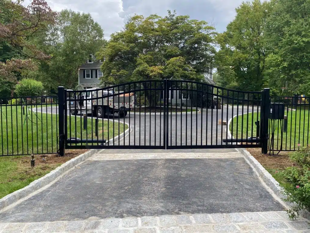 A modern fence gate design made of steel and wood panels for enhanced privacy and security.A modern fence gate design made of steel and wood panels for enhanced privacy and security.