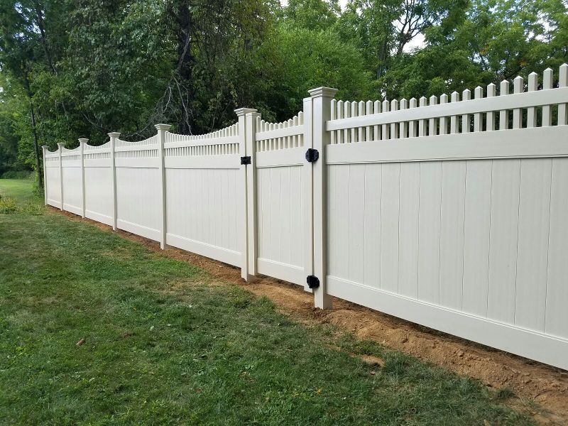 A durable wooden fence panel installed in a backyard, providing privacy and aesthetic appeal.